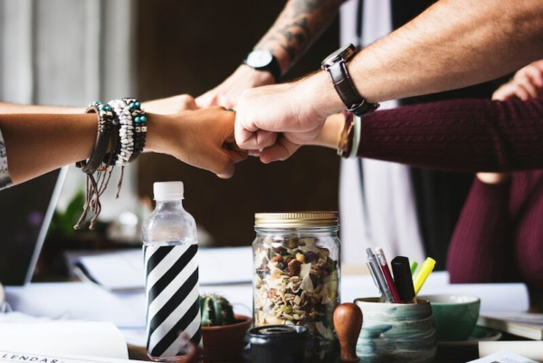 coworkers doing a team fist-bump