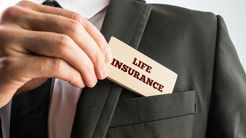 business man slipping life insurance card into his pocket