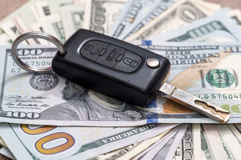 car key on top of cash