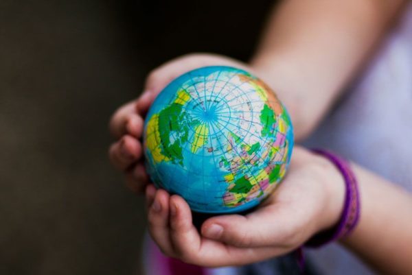 child holding tiny globe