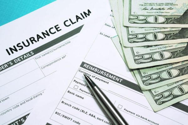 insurance claim form next to cash